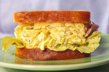 Egg salad sandwich on bread, served on a plate