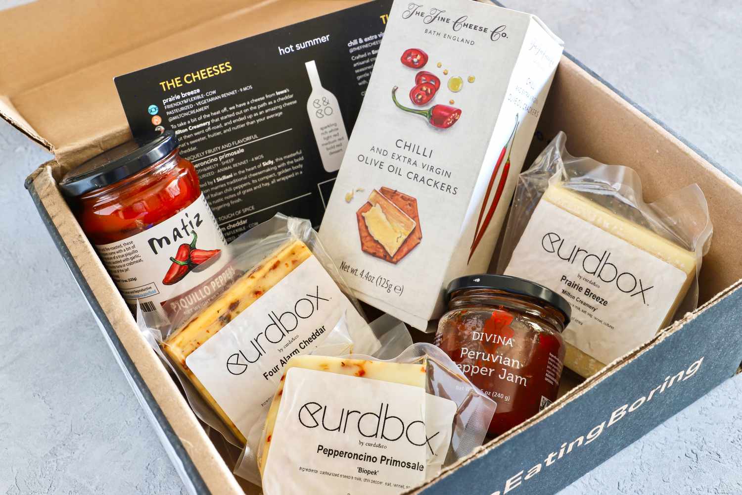 An assortment of gourmet cheese, crackers and spreads from Curdbox Cheese Subscription Box