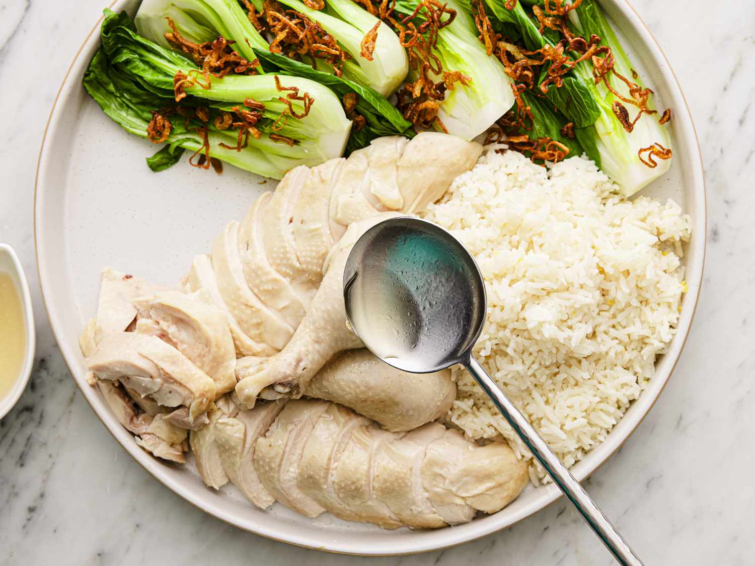 Broth being ladled over chicken