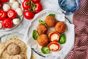 Fried caprese balls laid out on a plate.