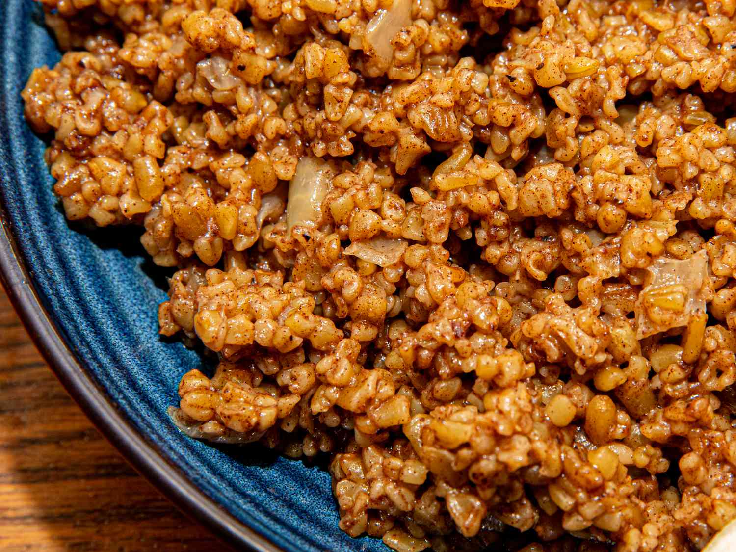 Overhead view of freekeh on a blue plate