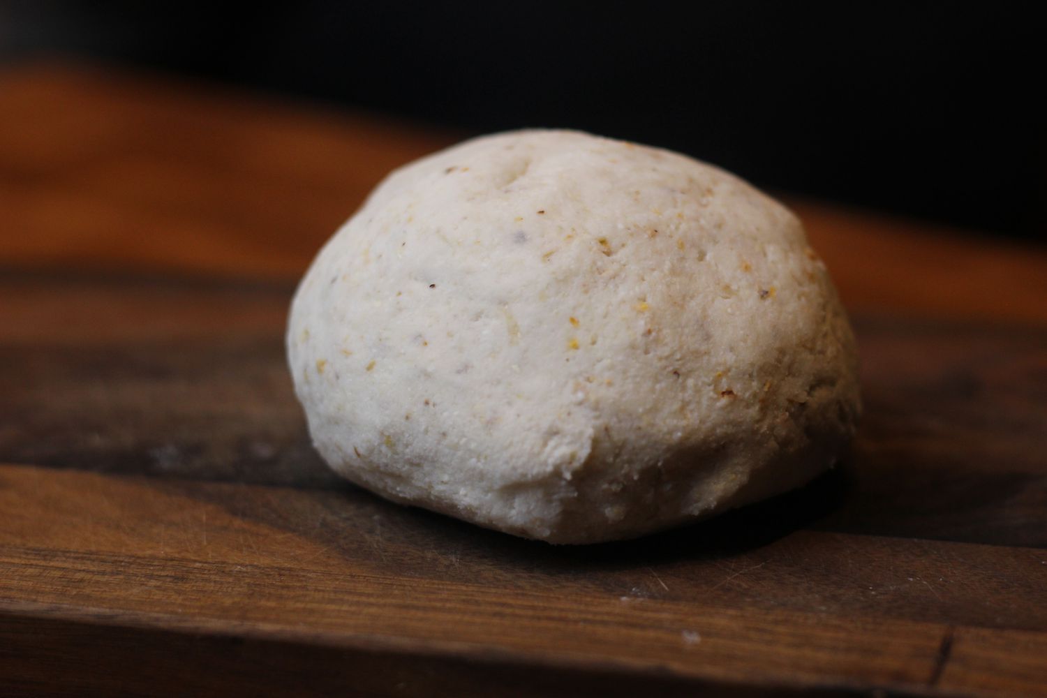 a ball of masa on a wooden countertop