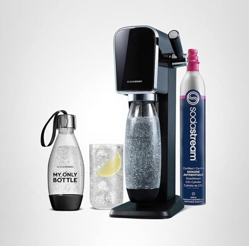 A soda maker with a labeled bottle a glass of sparkling water and a CO2 refill cylinder