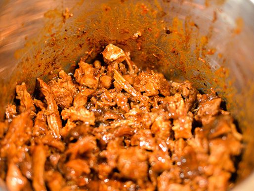 Closeup of the chopped lamb and reduced braising liquid after mixing.