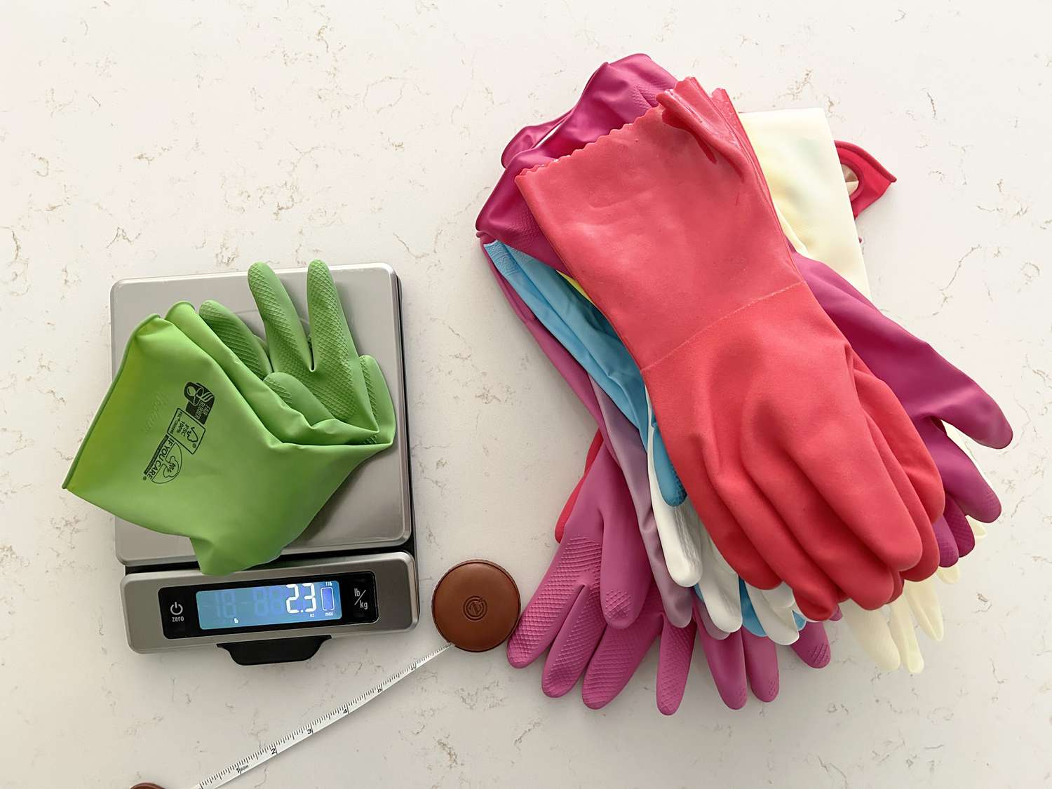 Dish gloves on a kitchen scale with a tape measure 