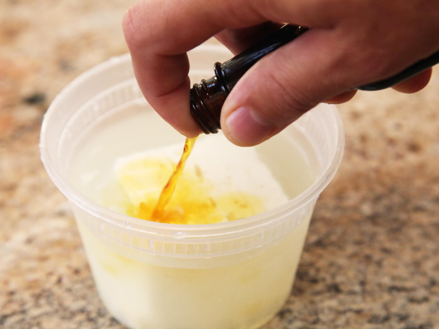 Liquid smoke is added to the feta submerged in brine.