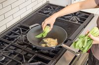Bok choi is added to the Misen 12 Inch Carbon Steel Wok