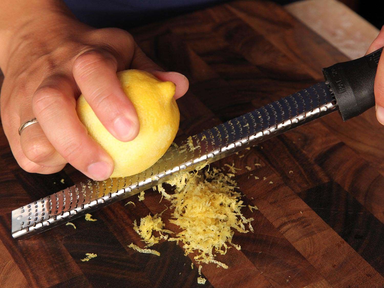 Zesting a lemon on a microplane for gremolata.