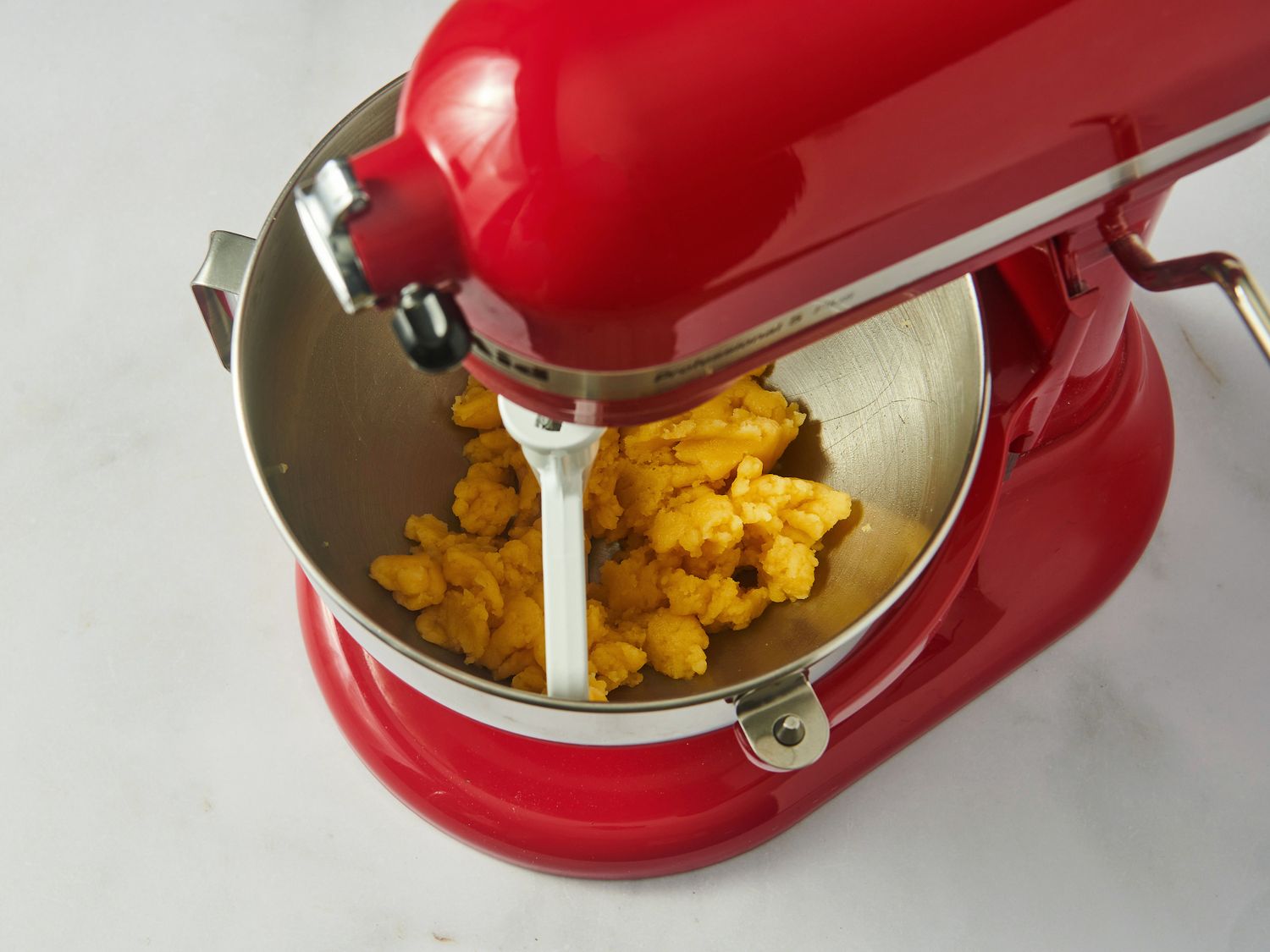 Choux pastry batter in the bowl of a stand mixer.