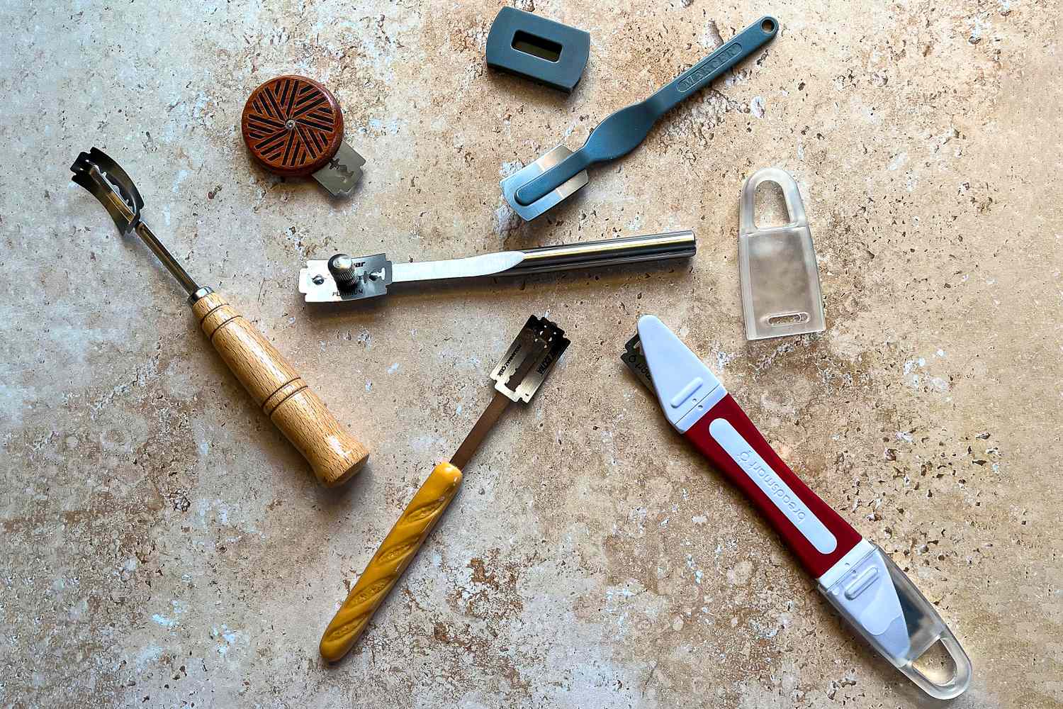 A collection of bread lames on a kitchen counter
