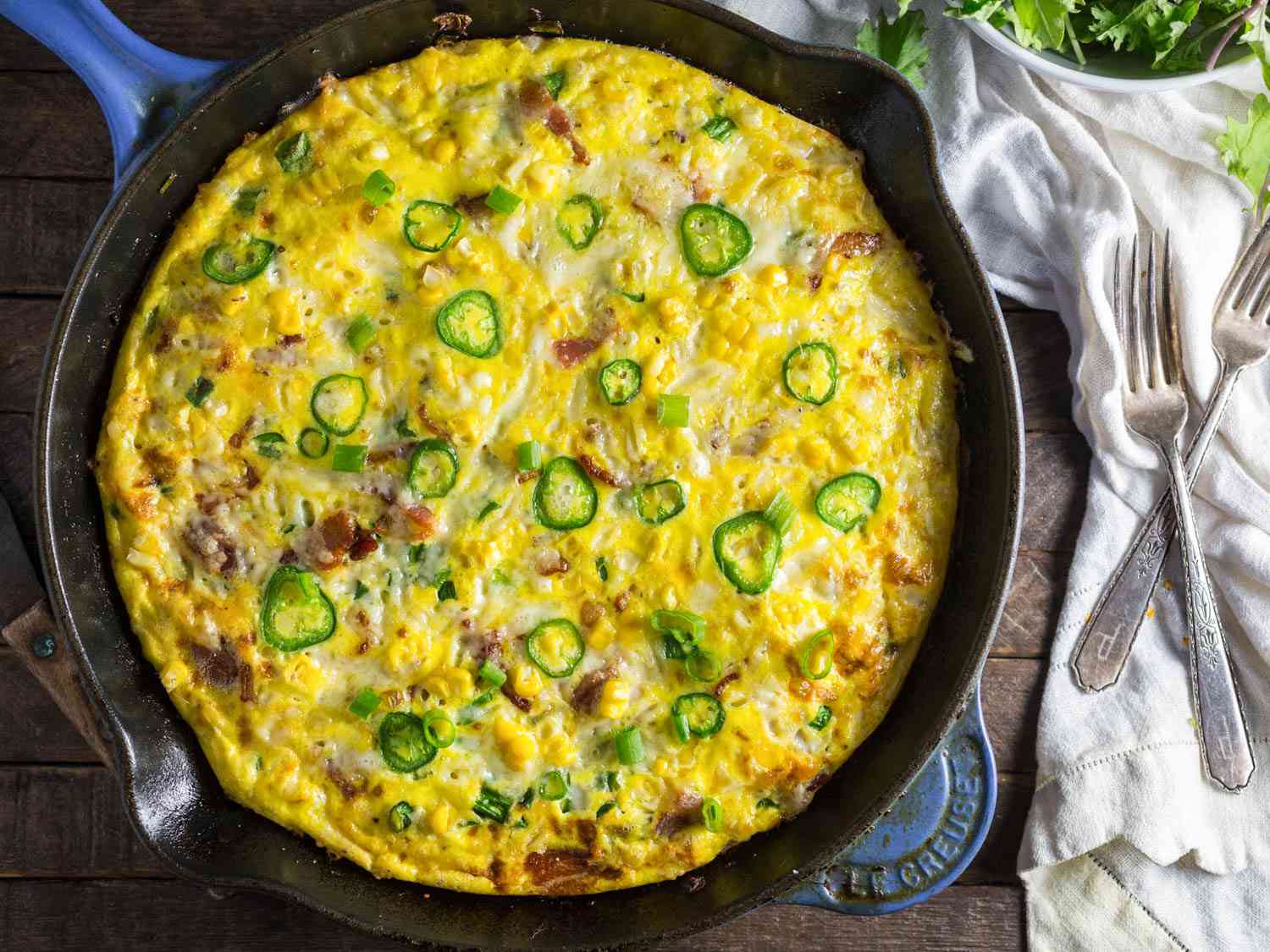 A bacon and corn frittata in a cast iron skillet.