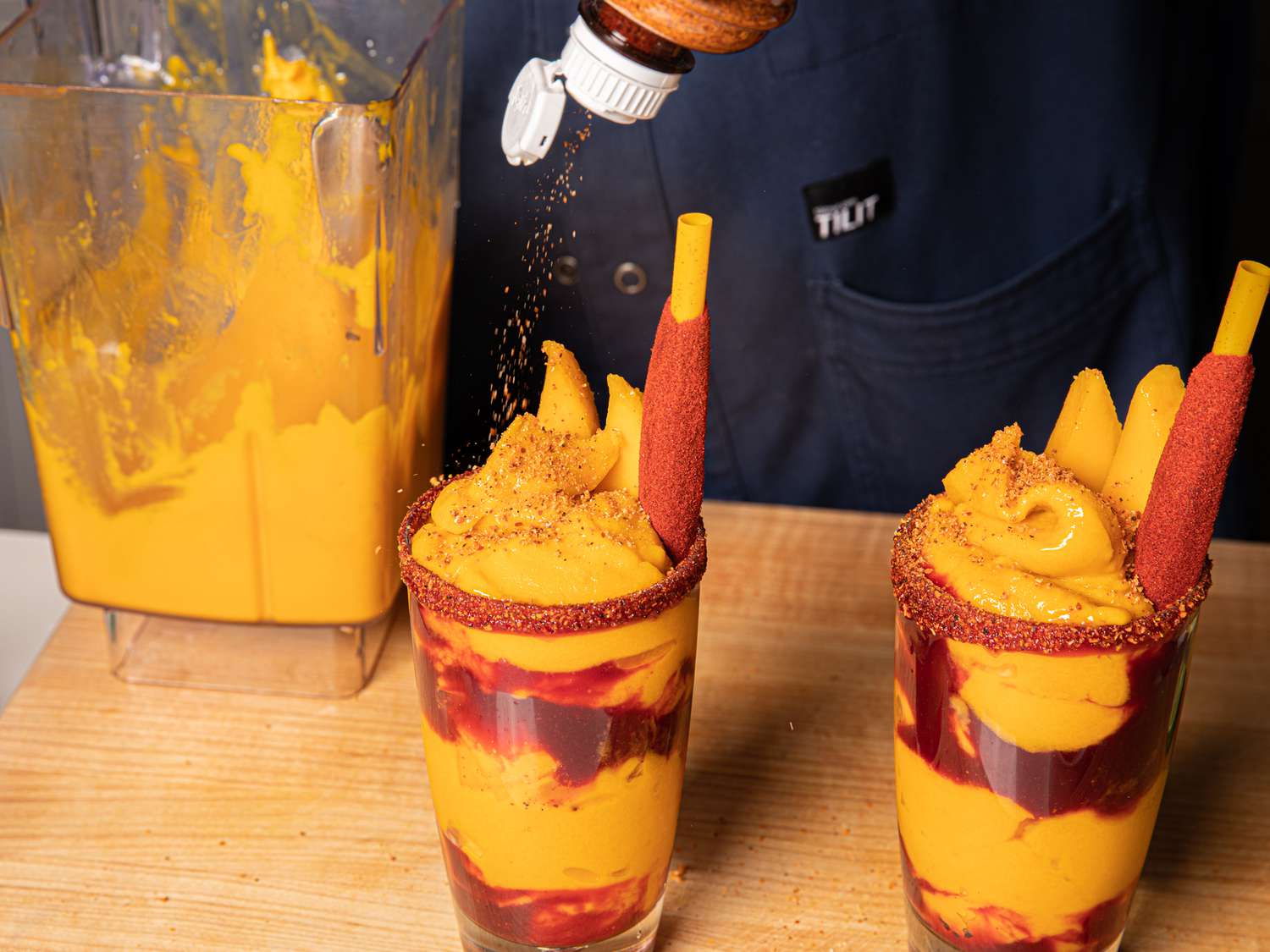 Finishing the mangonadas with TajÃ­n and garnishes
