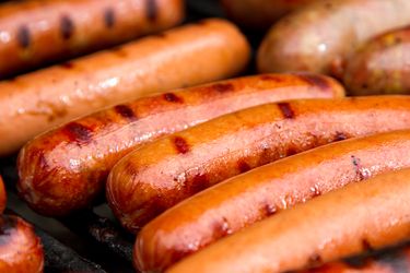 Closeup of grilled hot dogs and sausages on a grill