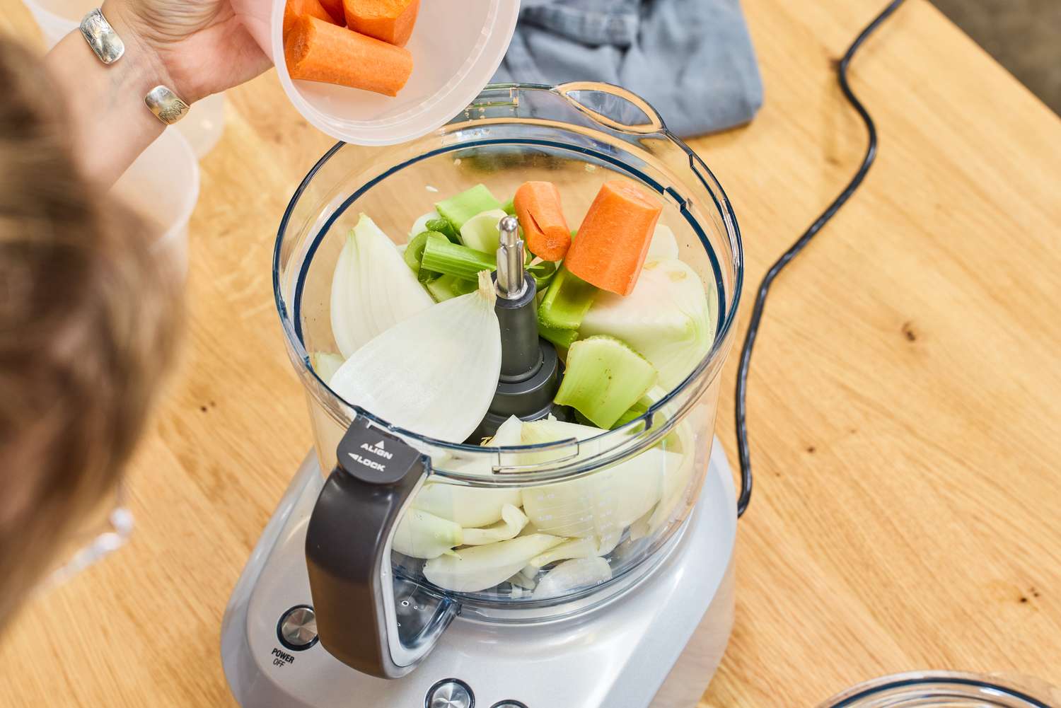Vegetables are seen inside the Breville BFP660SIL Sous Chef 12-Cup Food Processor