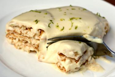 A fork taking a bite out of a cracker key lime pie.
