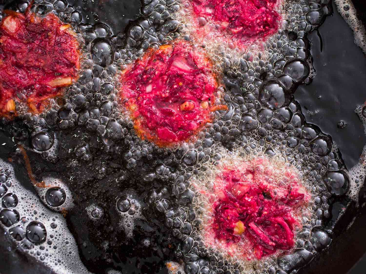 Beet latkes frying in oil