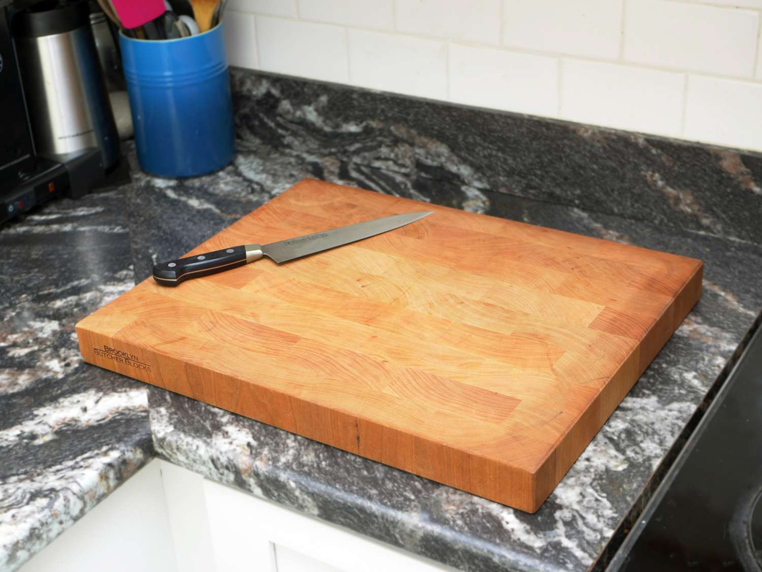 Brooklyn butcher blocks cutting board on countertop with chef's knife