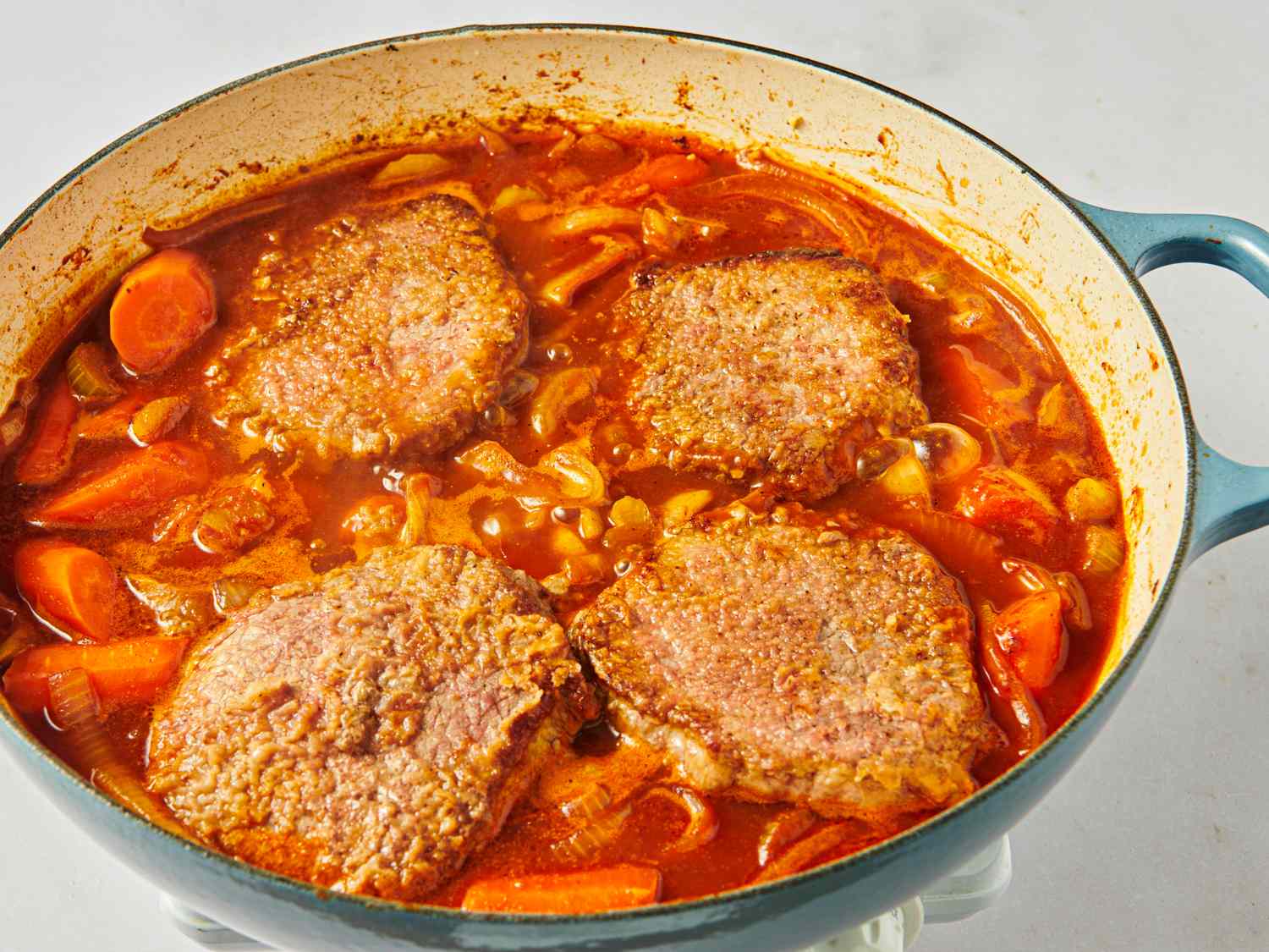 Swiss steak cooking in a pot