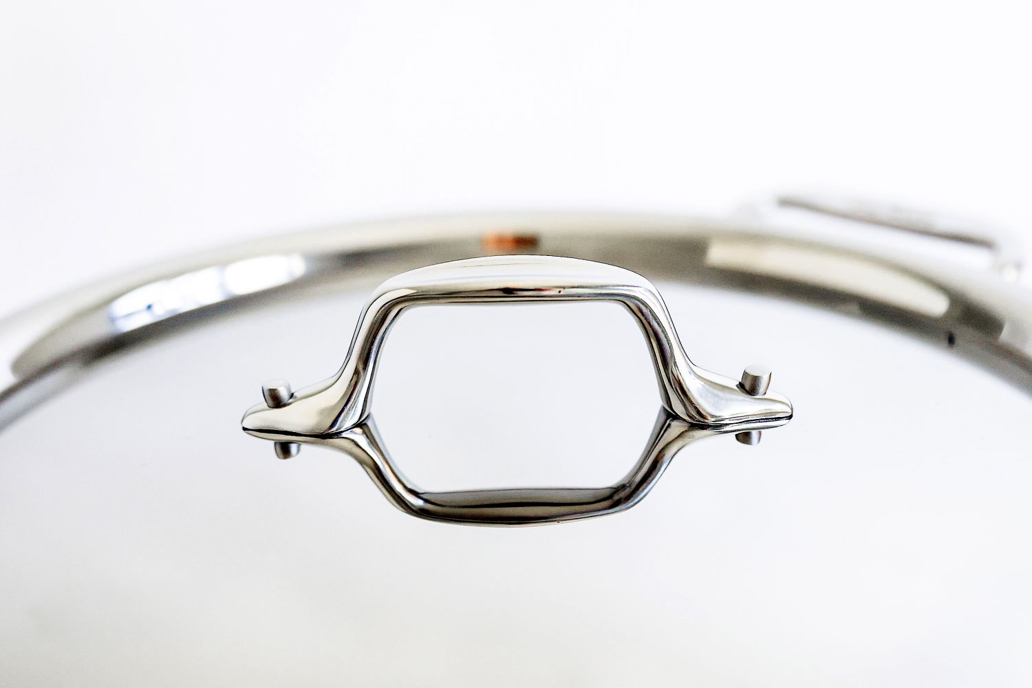 A close up of the lid handle on the All-Clad D3 3-Ply Stainless Steel Cookware Set 10 Piece