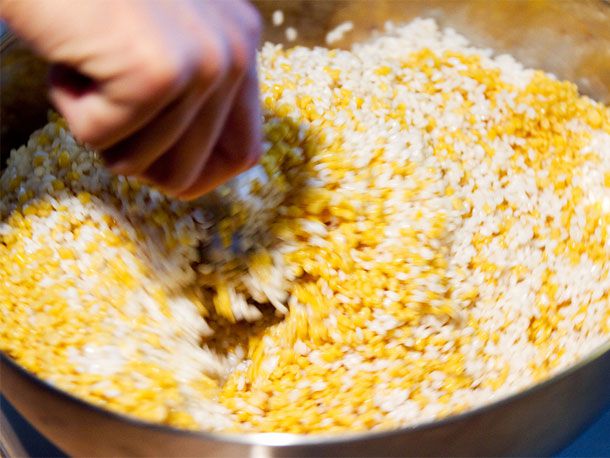 Mixing glutinous rice and mung beans in a large bowl.