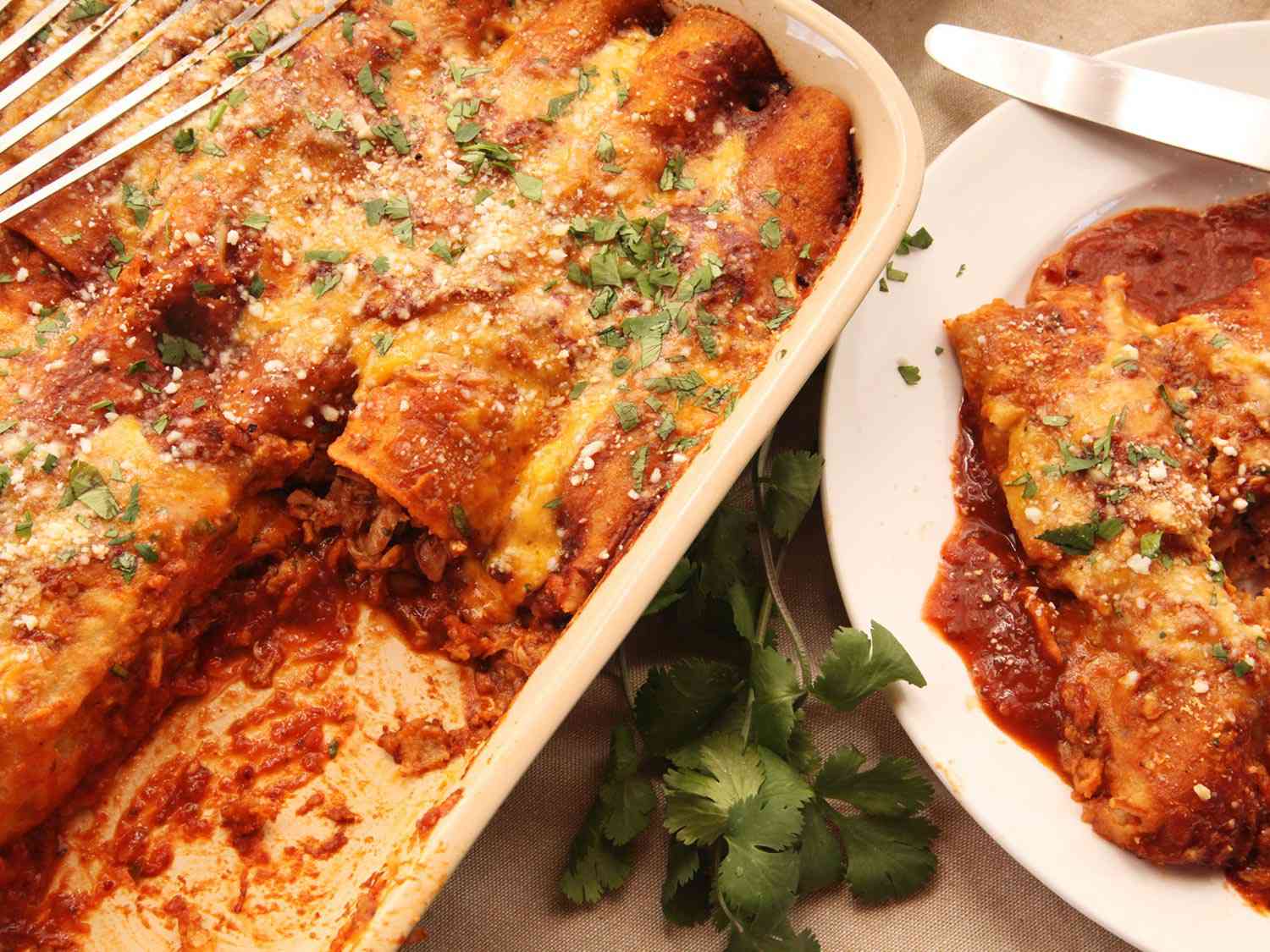 The finished enchiladas being served from the baking dish.