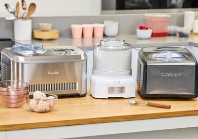 Three ice cream makers on a kitchen counter.