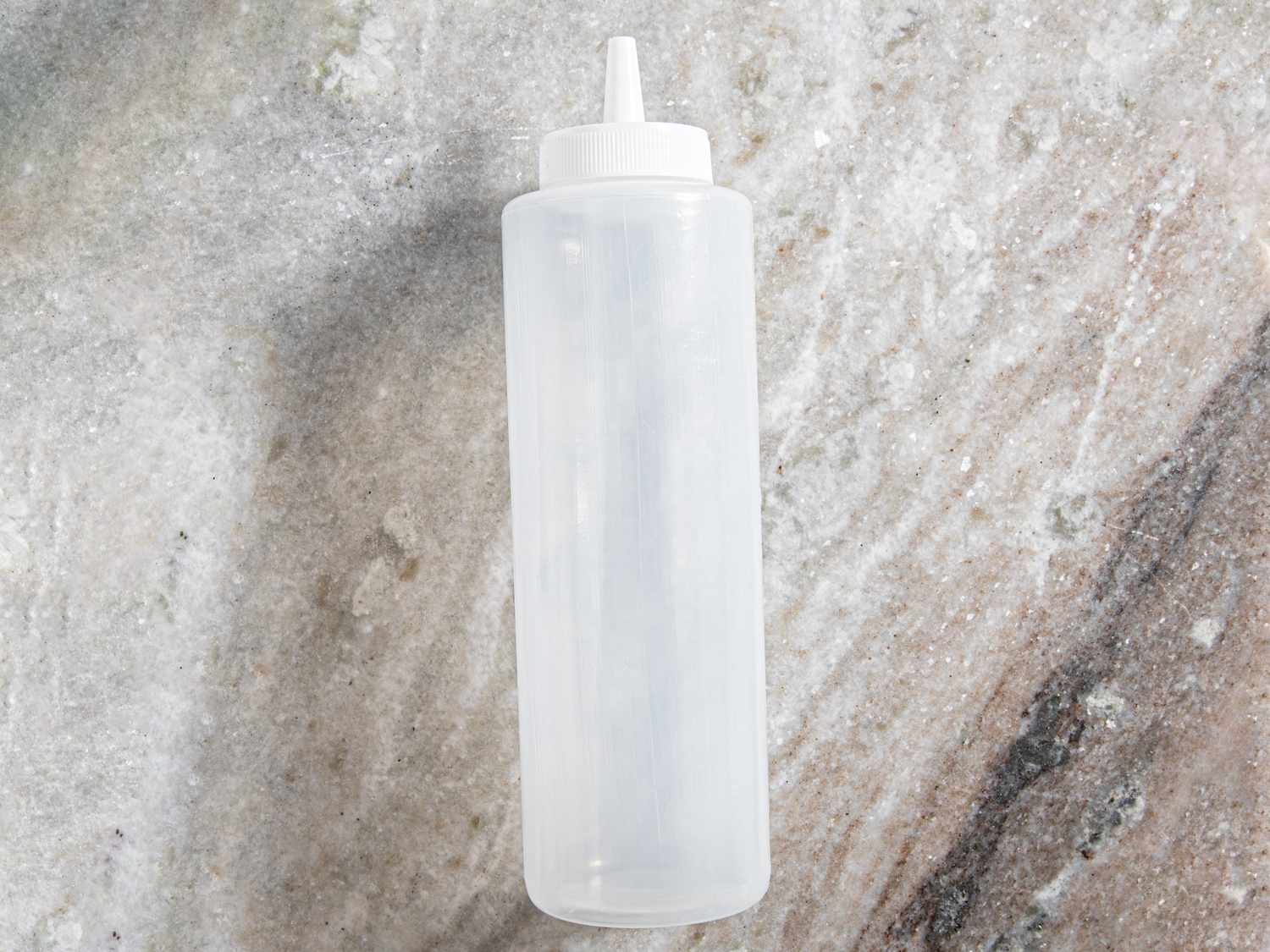 squeeze bottle on grey marble countertop