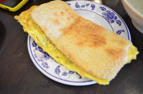 Baked wheat cake with scrambled egg filling, served on a plate.