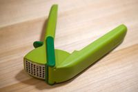 A garlic press on a wooden surface