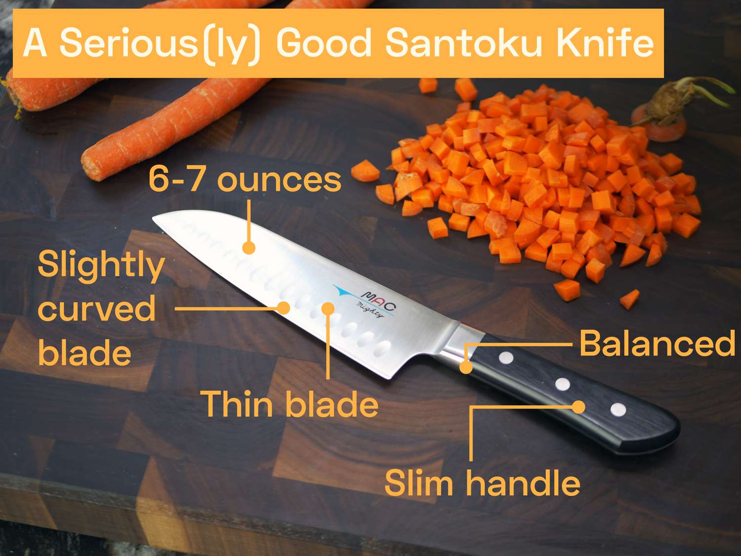 the Mac mighty santoku on a cutting board with diced carrot