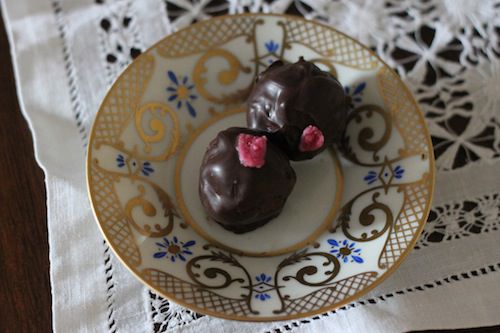 rosewater-raspberry dark chocolate truffles on a plate