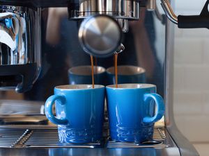pouring espresso into Le Creuset Espresso Mugs 