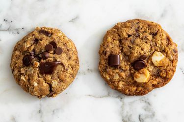 Two cookies side-by-side on a marble surface.