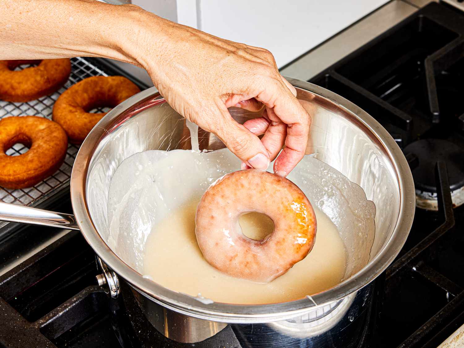Overhead view of glazing donuts