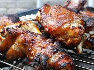 Closeup of pig's feet being finished on a grill.