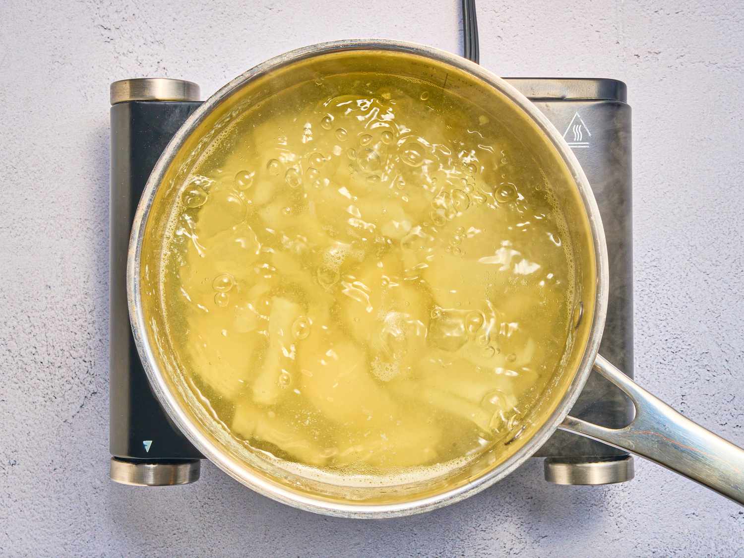 potatoes boiling in a saucepan
