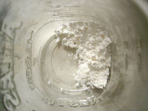 The bottom of a glass jar filled with cornstarch