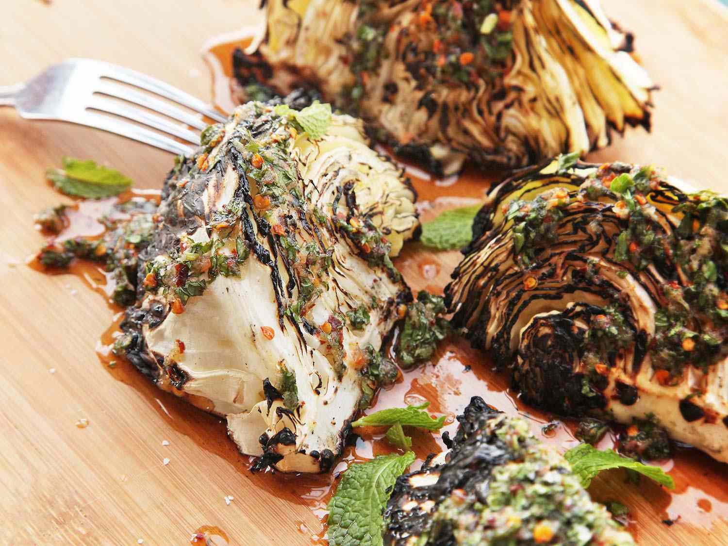 Grilled wedges of cabbage with spicy Thai dressing and mint leaves