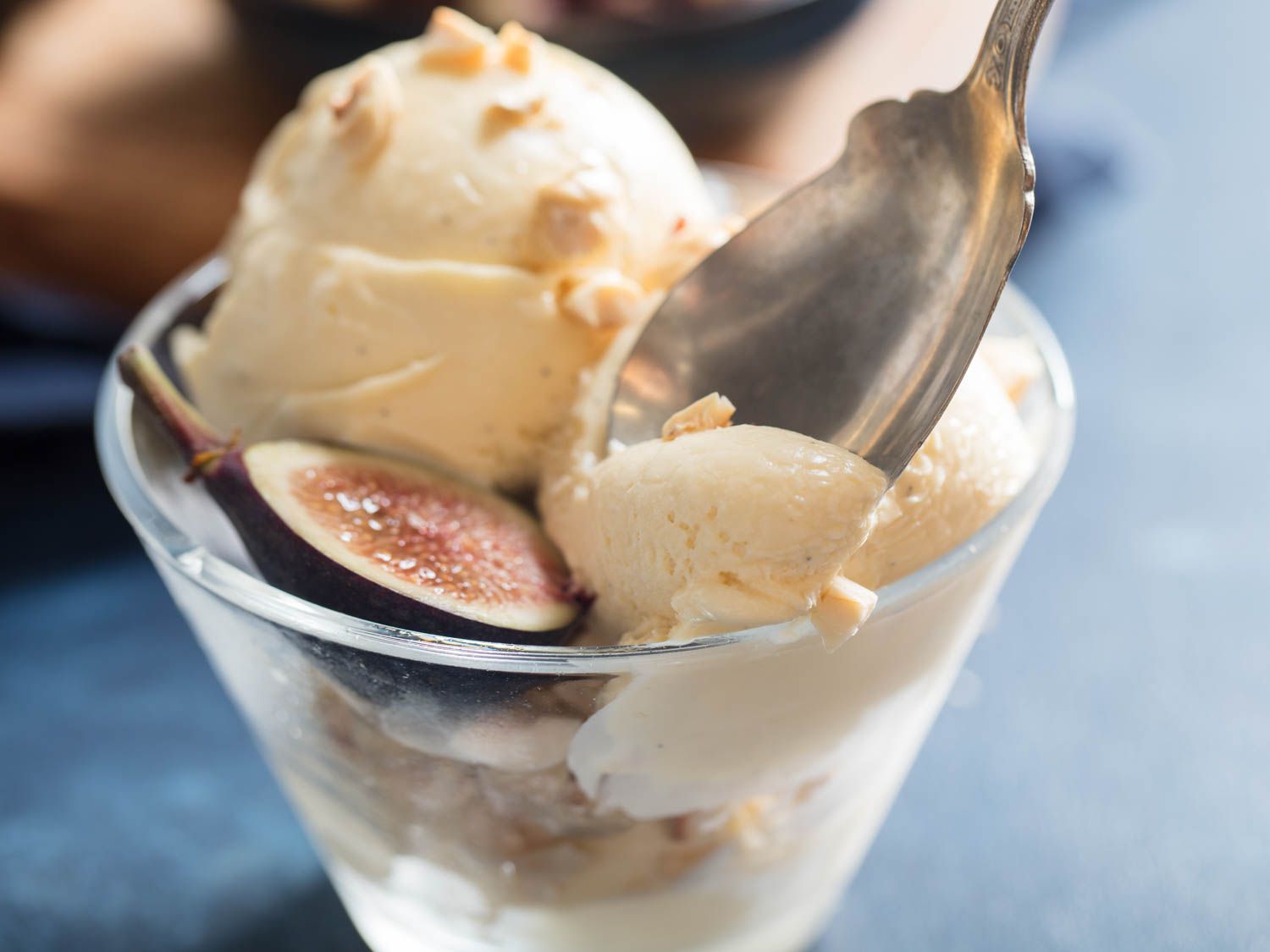 A serving glass of hazelnut ice cream with fresh fig.