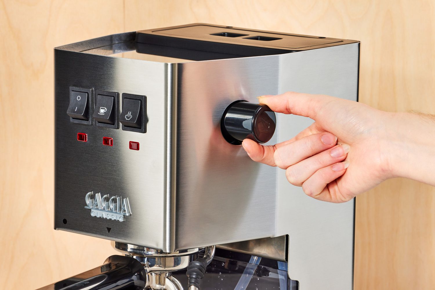 Hand adjusting the side control knob of the Gaggia Classic Pro Espresso Machine