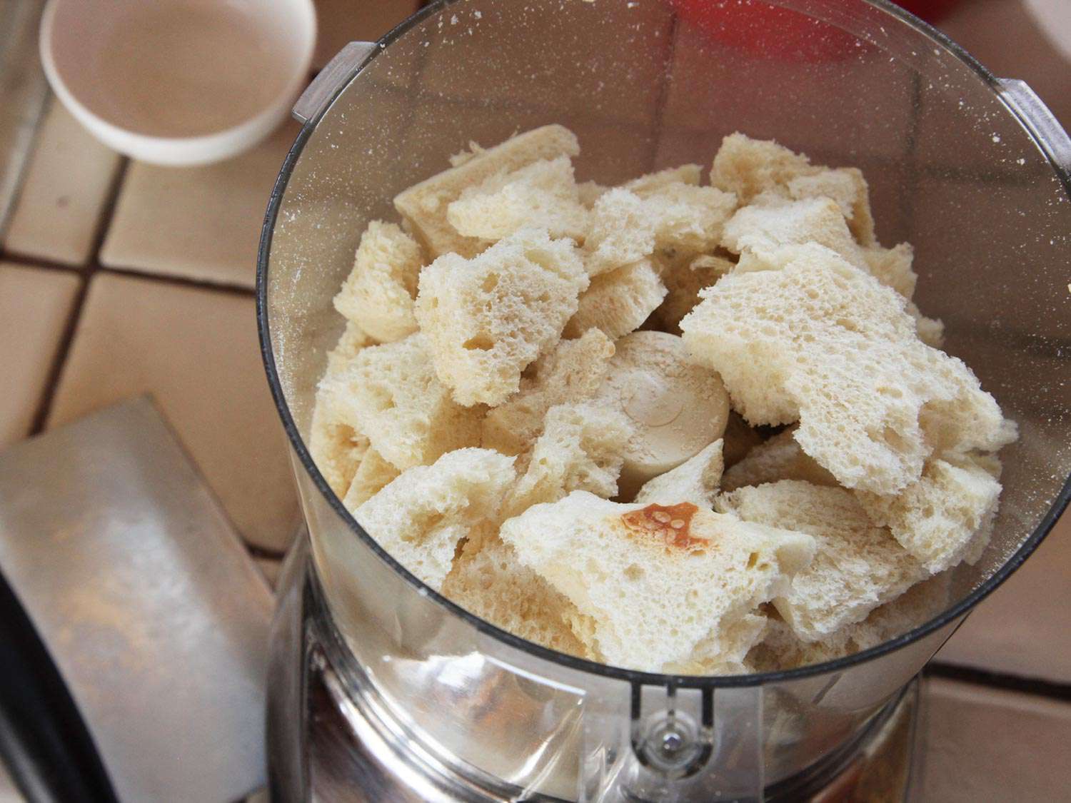 Chunks of crustless bread in food processor bowl
