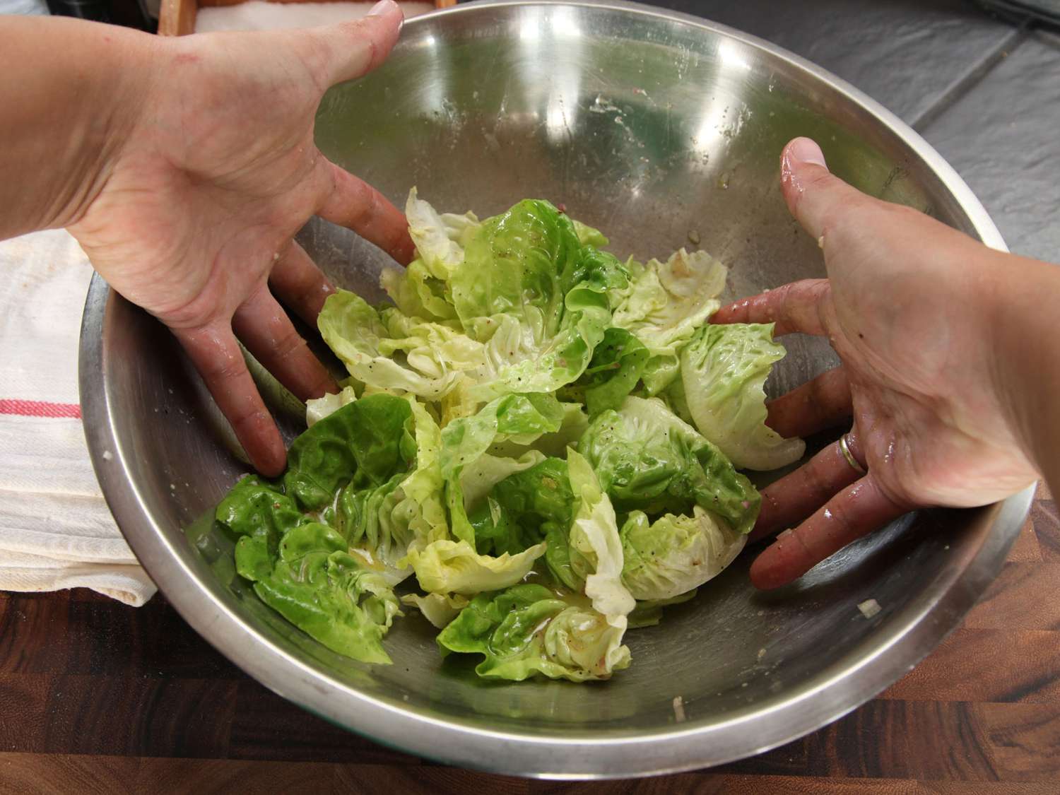 Author tosses the salad with his hands.