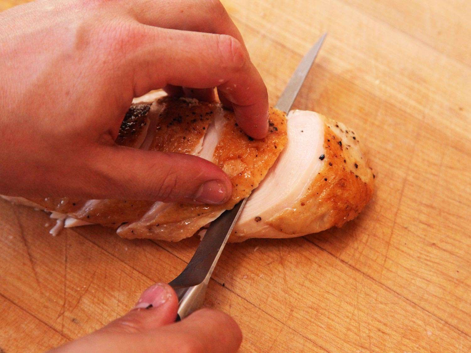 Slicing chicken breast cooked sous vide and finished on the stovetop.