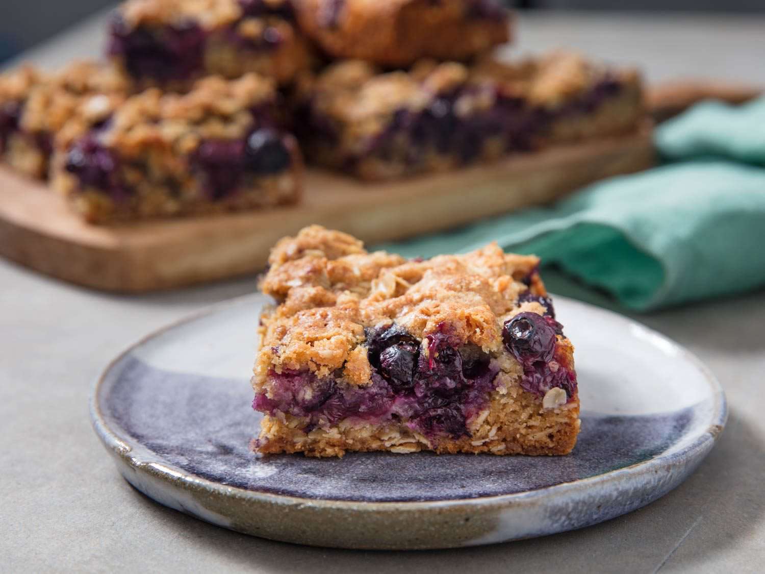 Oatmeal bar cookies with fresh blueberries on a plate.