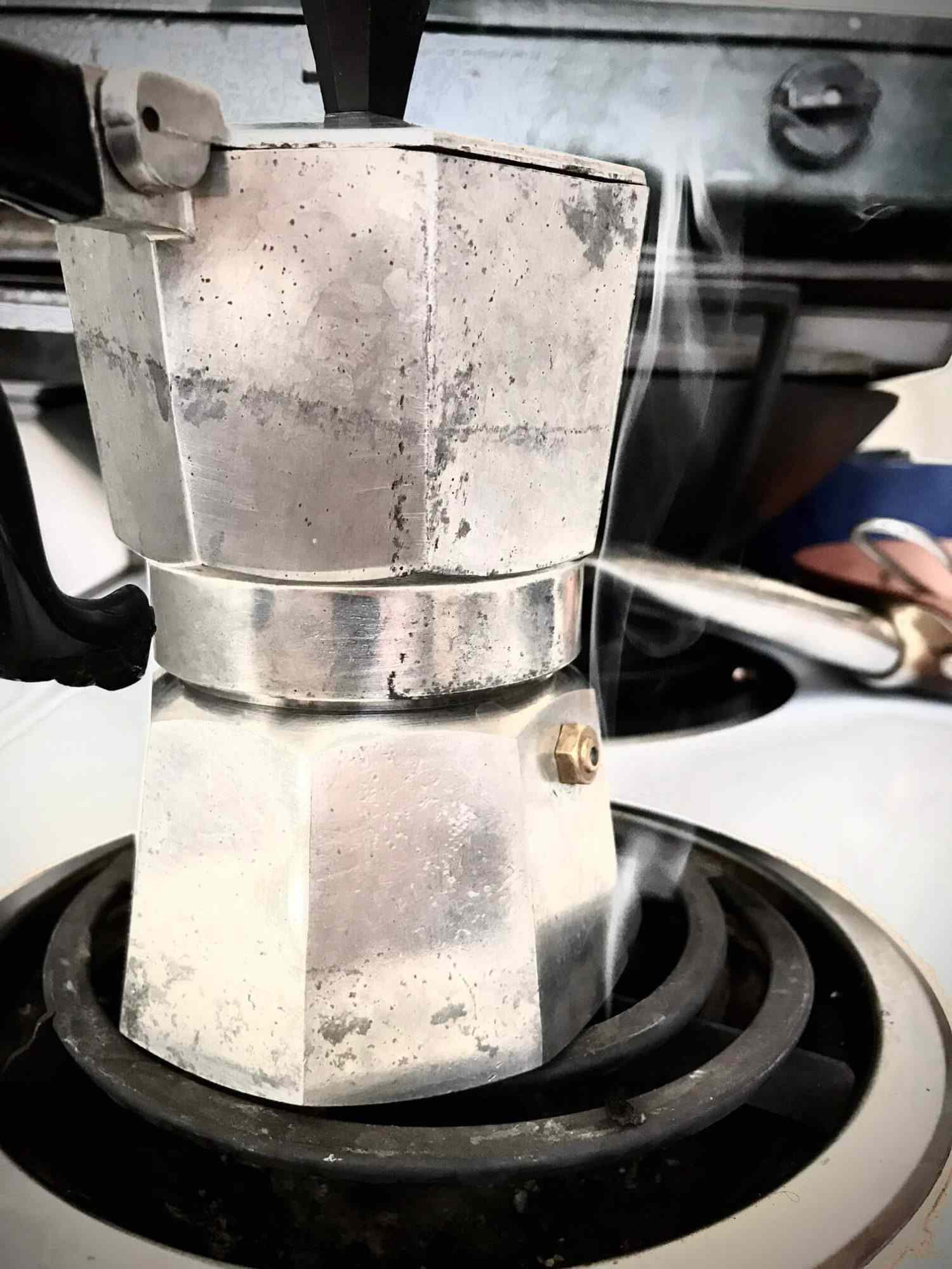 A moka pot on a burner