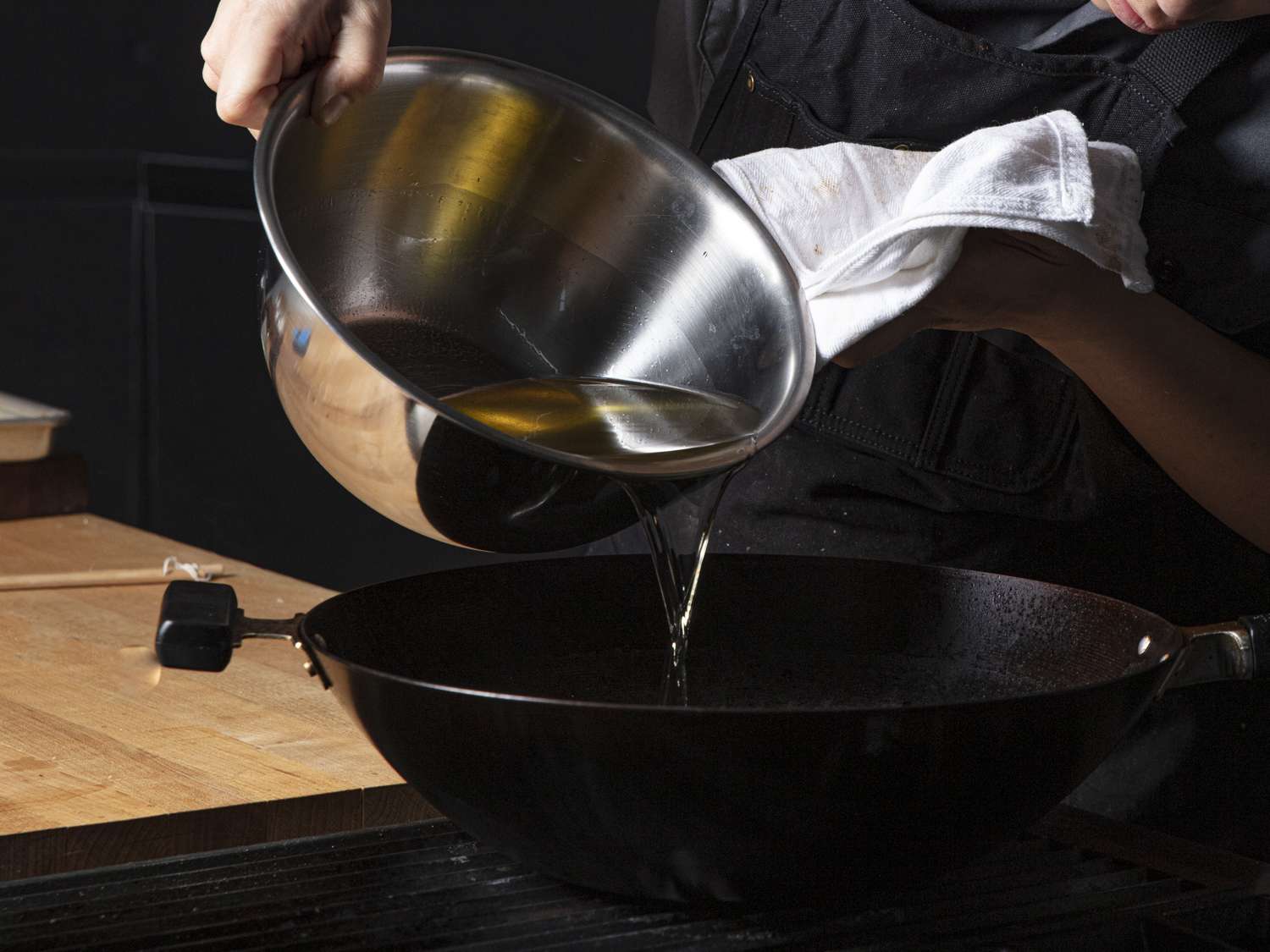 Oil being poured into a wok