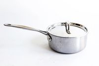 A pot with a lid from the Goldilocks 7-piece Cookware Set on a white surface