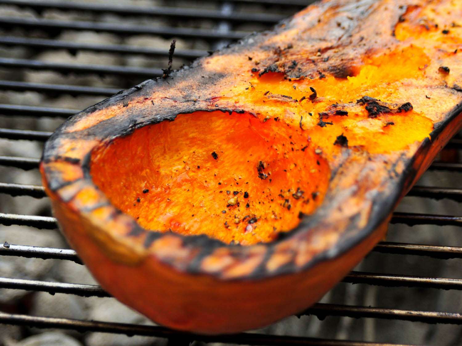A half a butternut squash being grilled 