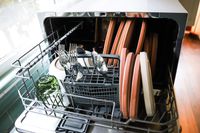 The Danby countertop dishwasher filled with dishes and silveware.