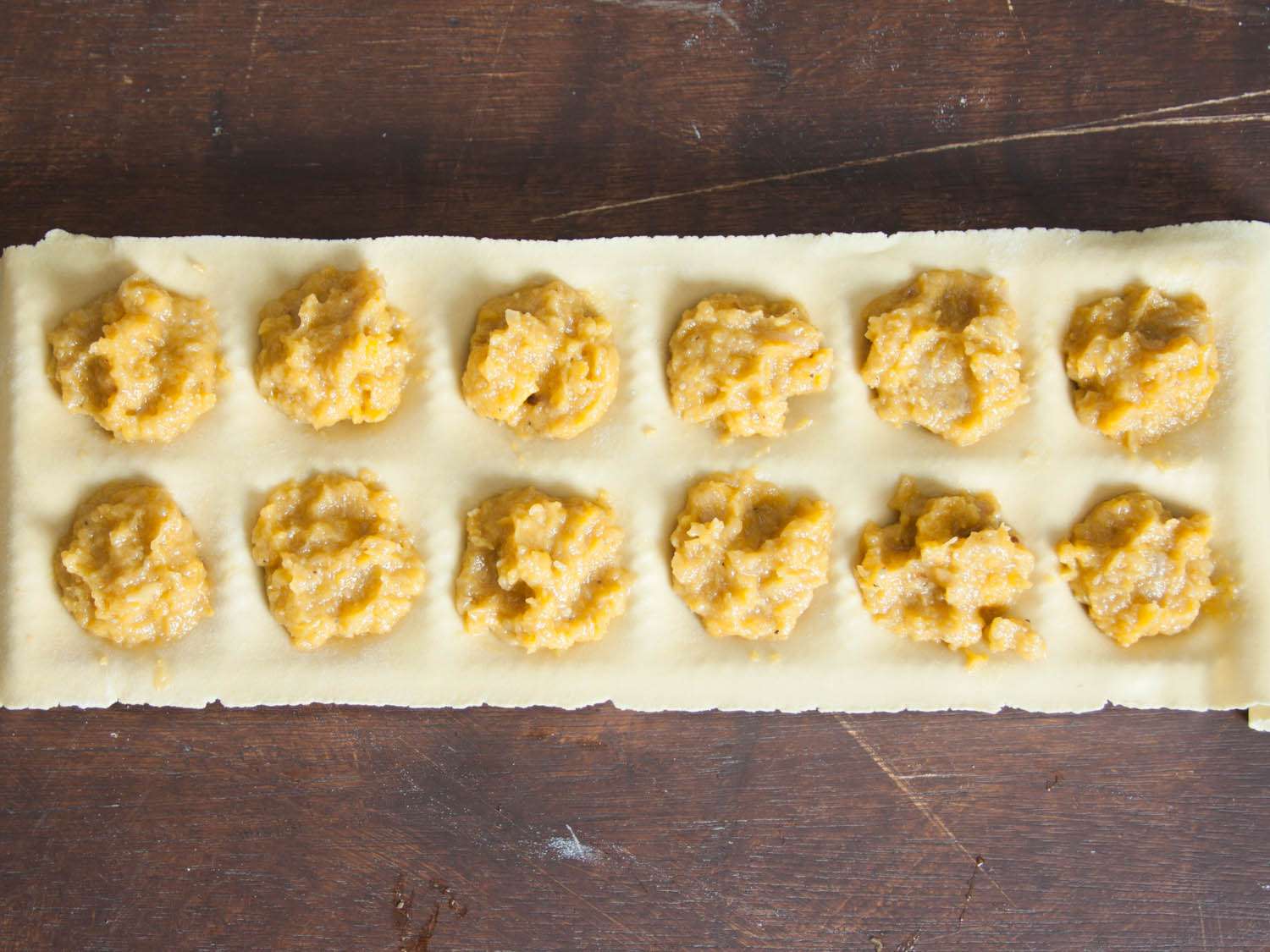 The depressions in the fresh pasta are filled with a butternut squash filling.